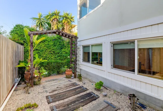 a view of a chairs and table in backyard of the house