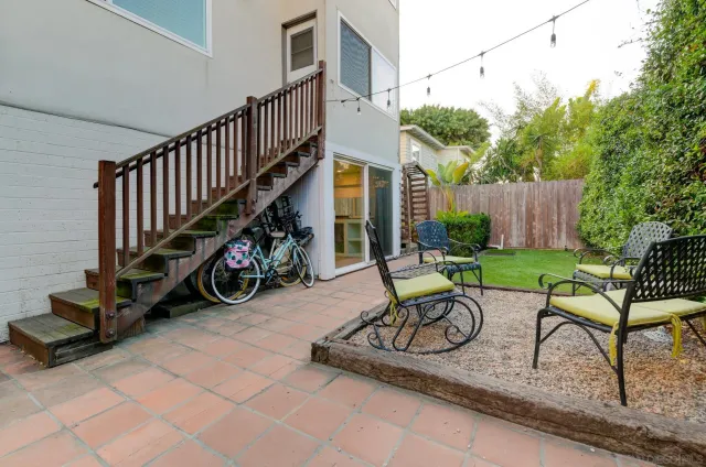 a view of a patio with a table and chairs