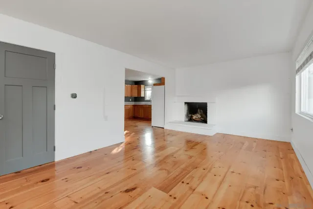 a view of a livingroom with wooden floor and a flat screen tv