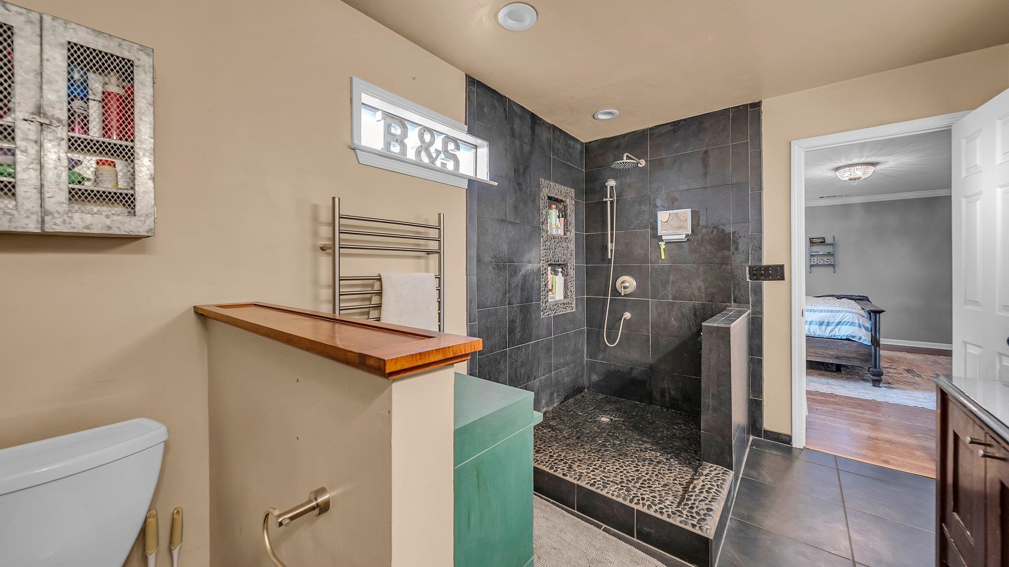 1415 Rosemark Road Atoka, TN 38004 - Photo 11 of 20 Bathroom featuring tile patterned floors, radiator, a tile shower, and toilet