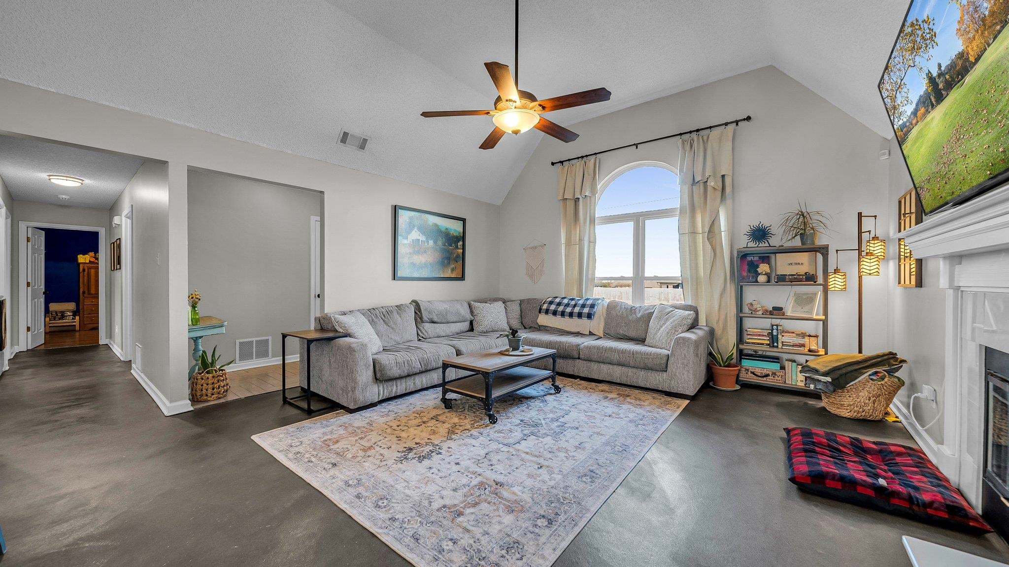 1415 Rosemark Road Atoka, TN 38004 - Photo 6 of 20 Living room with ceiling fan, a textured ceiling, and high vaulted ceiling