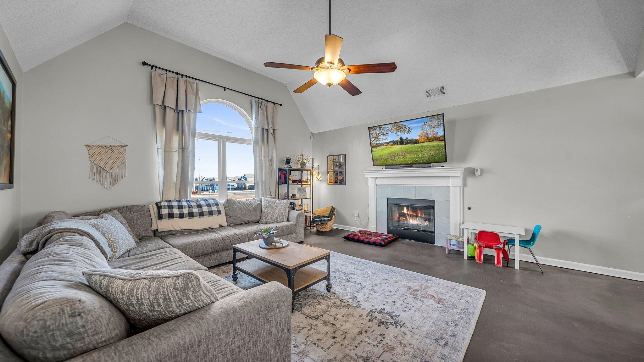 1415 Rosemark Road Atoka, TN 38004 - Photo 7 of 20 Living room featuring a fireplace, ceiling fan, and lofted ceiling