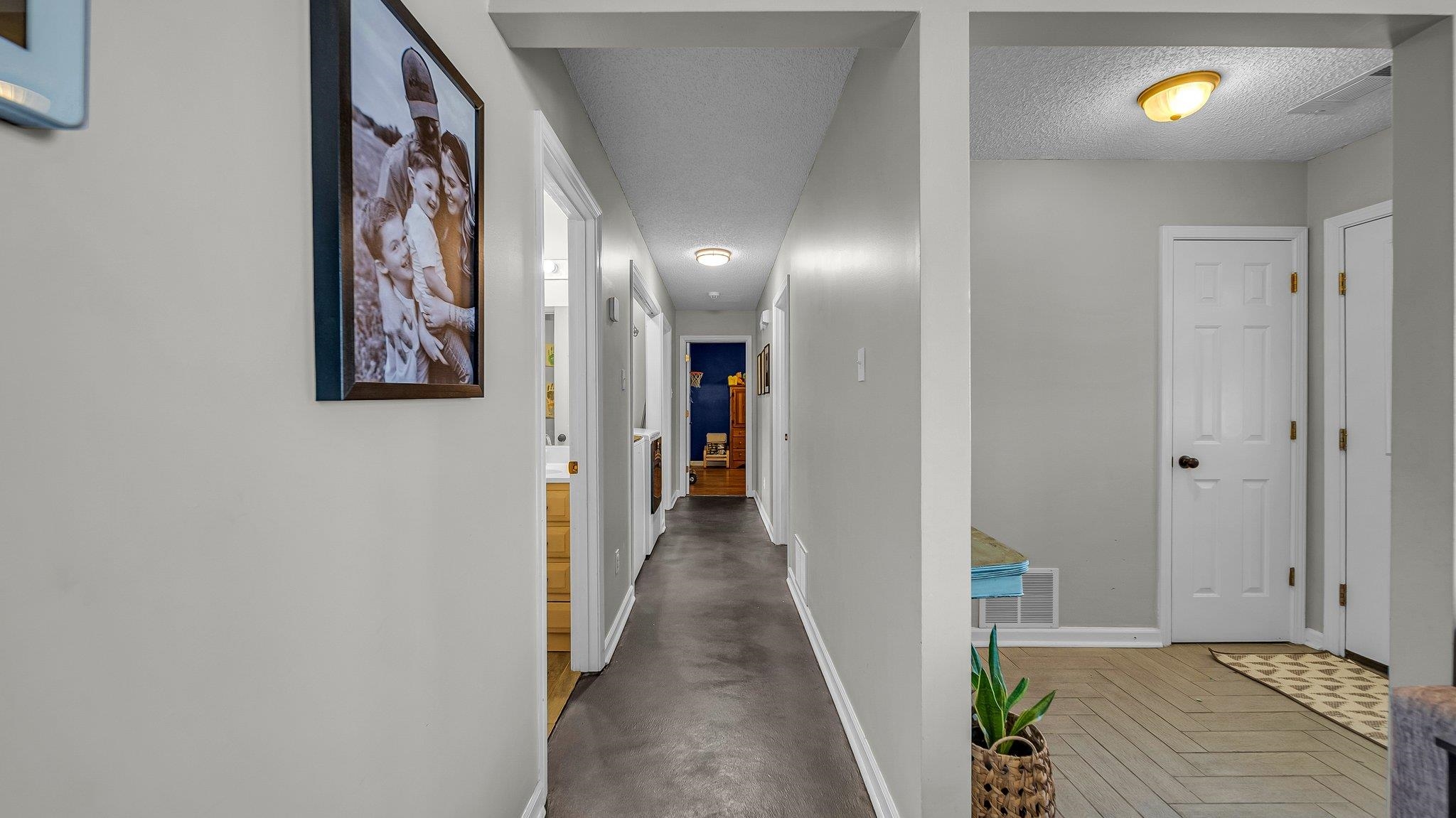 1415 Rosemark Road Atoka, TN 38004 - Photo 8 of 20 Hall with a textured ceiling and parquet flooring