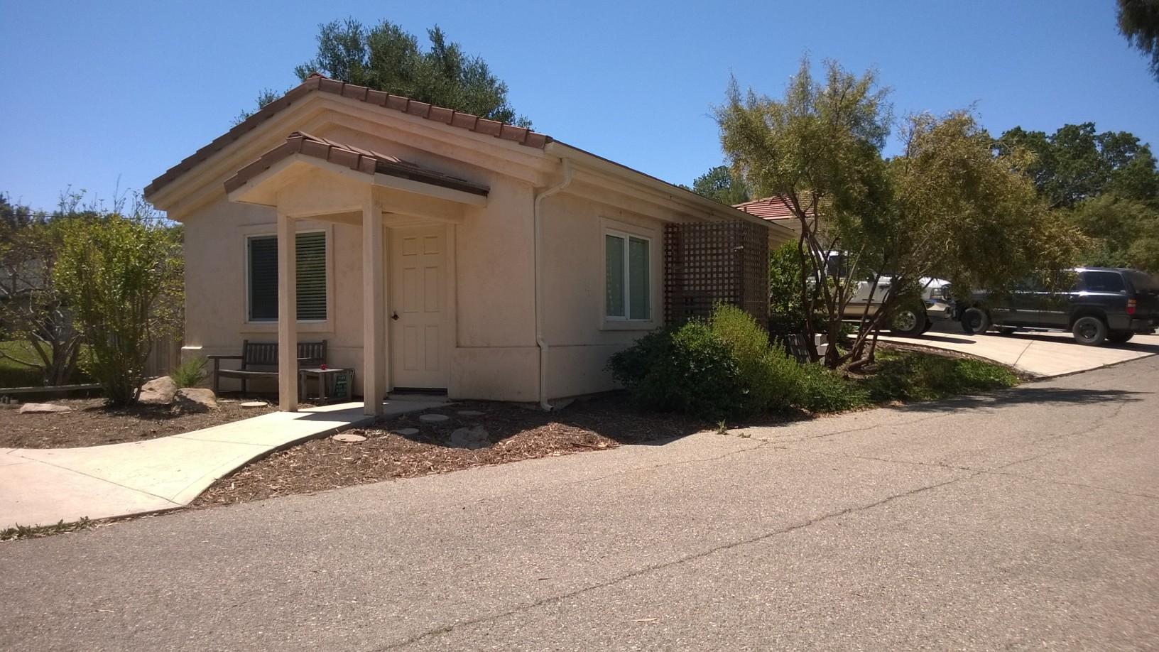 765 Alamo Pintado Road Solvang, CA 93463 - Photo 18 of 21 a front view of a house with a yard and garage