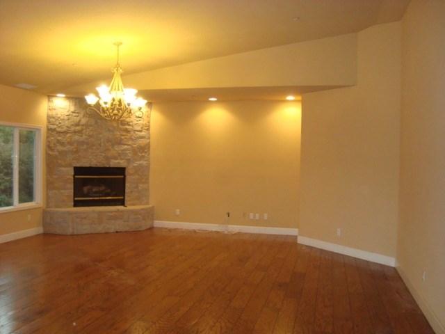 765 Alamo Pintado Road Solvang, CA 93463 - Photo 5 of 21 an empty room with a fireplace and chandelier fan