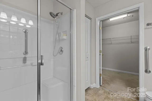 a bathroom with a glass shower door