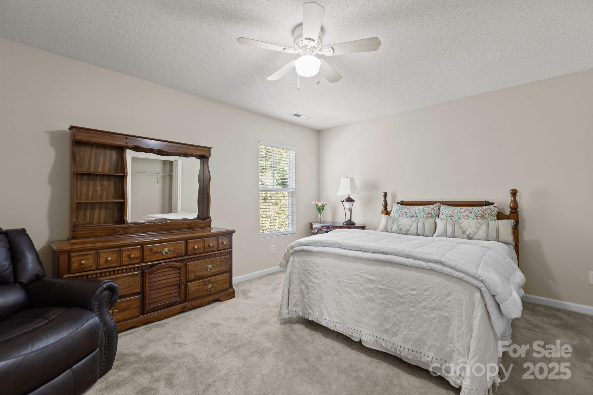 6839 Harter Court, Unit 35 Raleigh, NC 27610 - Photo 30 of 43 a spacious bedroom with a bed and furniture