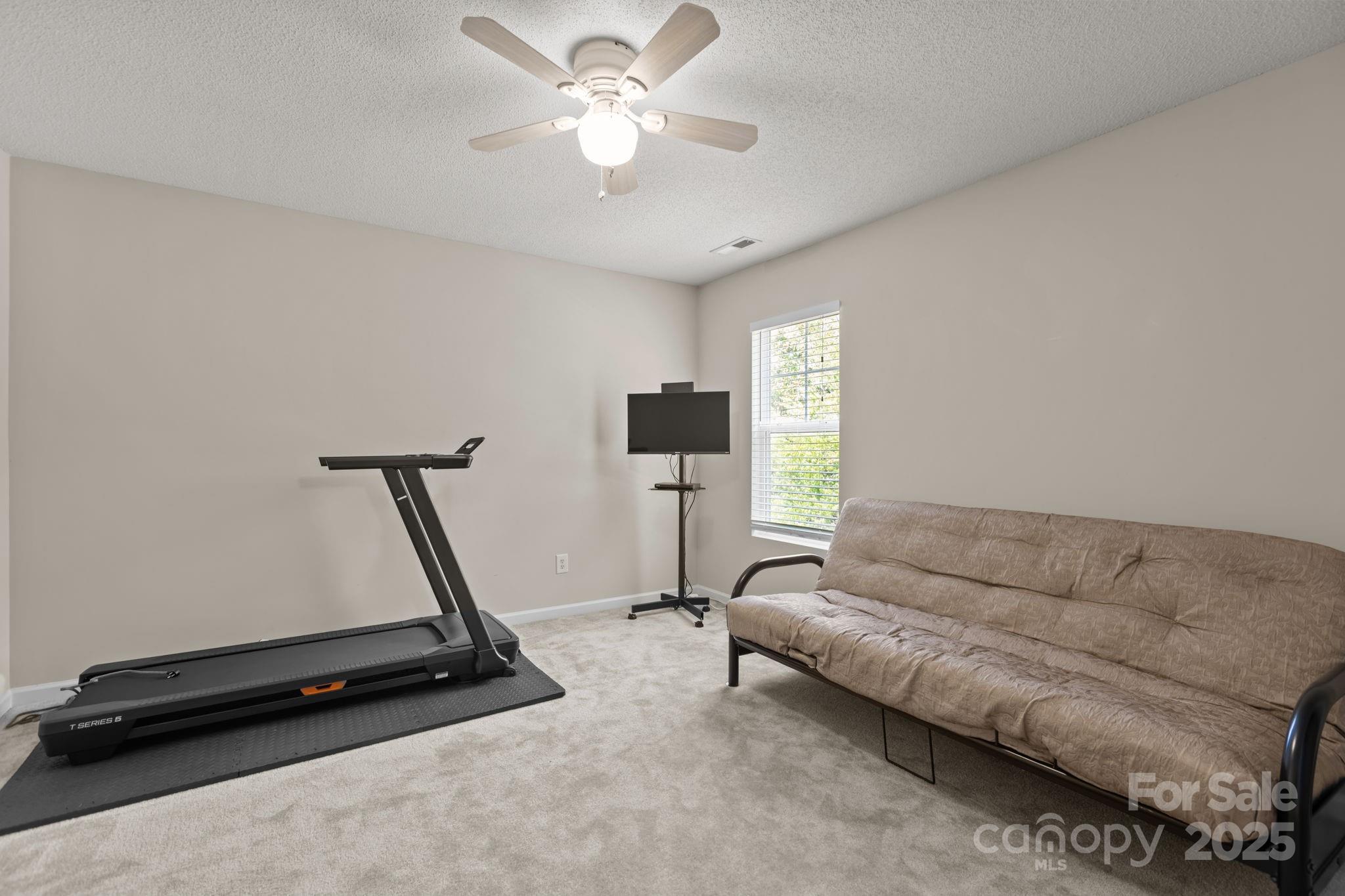 6839 Harter Court, Unit 35 Raleigh, NC 27610 - Photo 31 of 43 a living room with furniture and a chandelier