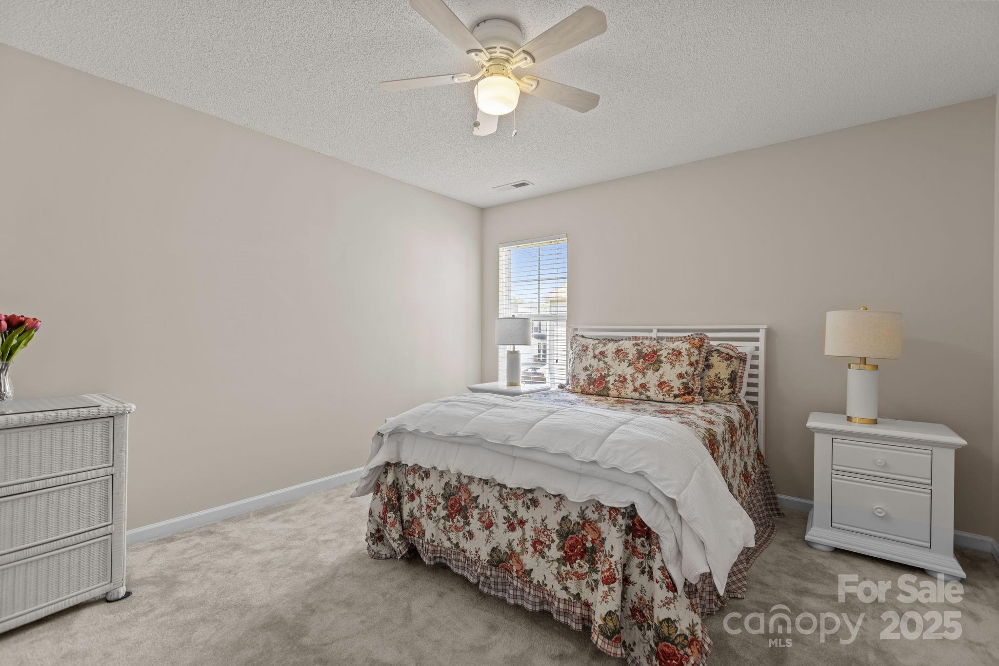 6839 Harter Court, Unit 35 Raleigh, NC 27610 - Photo 32 of 43 a bedroom with a bed and a chandelier