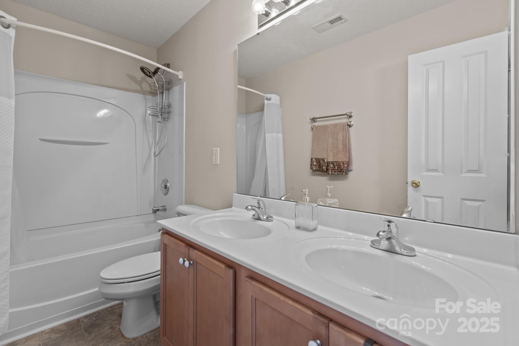 6839 Harter Court, Unit 35 Raleigh, NC 27610 - Photo 33 of 43 a bathroom with a granite countertop sink toilet and shower