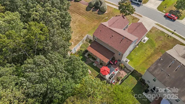 an aerial view of a house with a yard and swimming pool