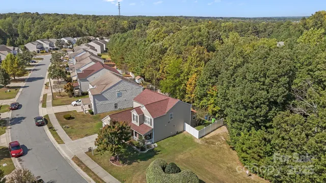 an aerial view of a house with a yard
