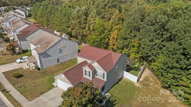 an aerial view of a house with a yard