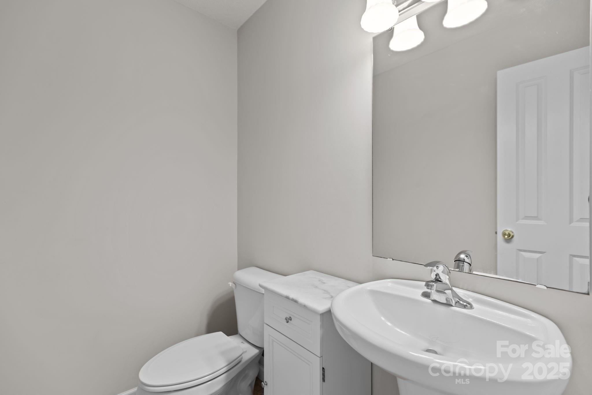 6839 Harter Court, Unit 35 Raleigh, NC 27610 - Photo 8 of 43 a bathroom with a sink a toilet and mirror