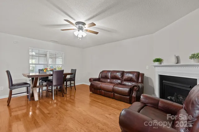 a living room with furniture a fireplace and a window
