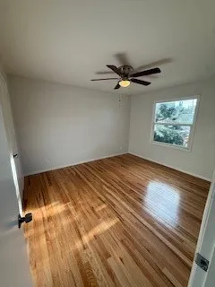 a view of a room with wooden floor