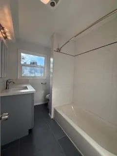 a bathroom with a bathtub and a shower