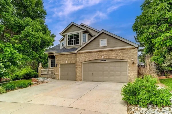 a front view of a house with a garage and yard