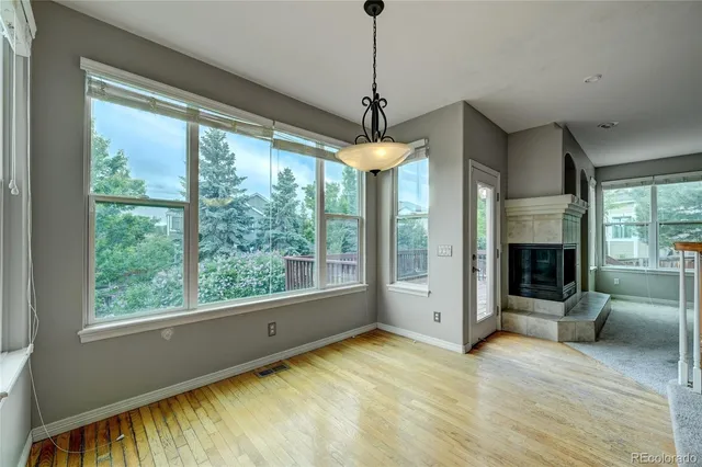 a view of a livingroom with a fireplace and a ceiling fan
