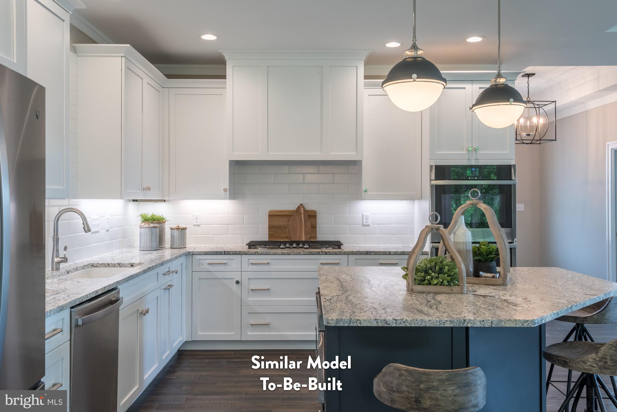 Lot#57 Patton Road Harrisburg, PA 17112 - Photo 4 of 11 a kitchen with granite countertop kitchen island white cabinets and refrigerator