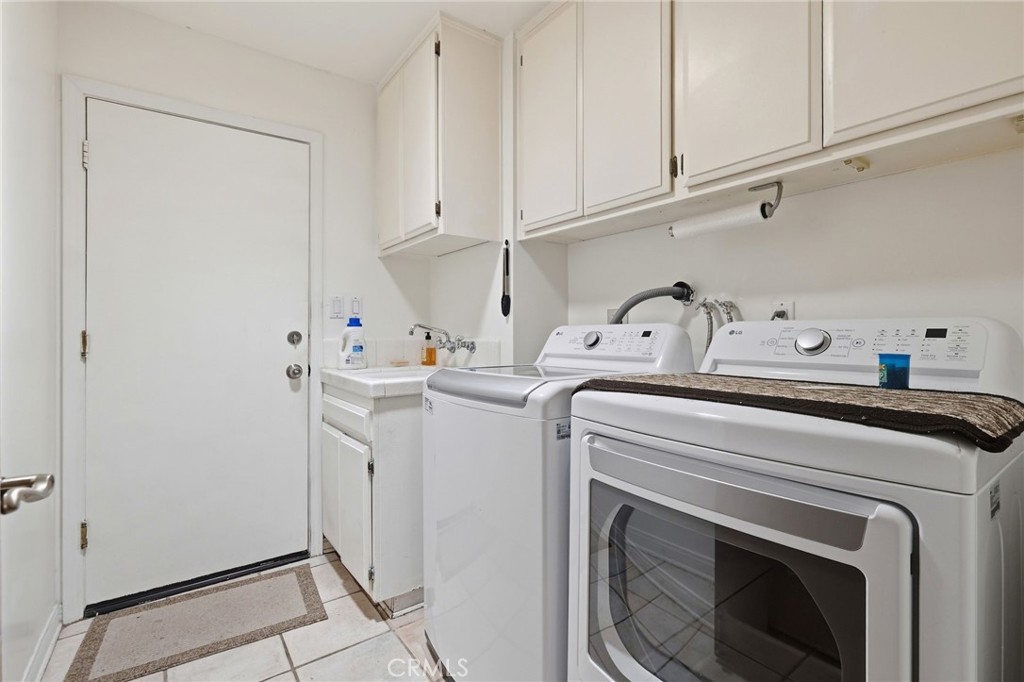 18233 Charlton Lane Porter Ranch, CA 91326 - Photo 21 of 40 a utility room with dryer and washer