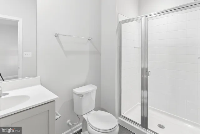 a white toilet sitting next to a bathroom sink