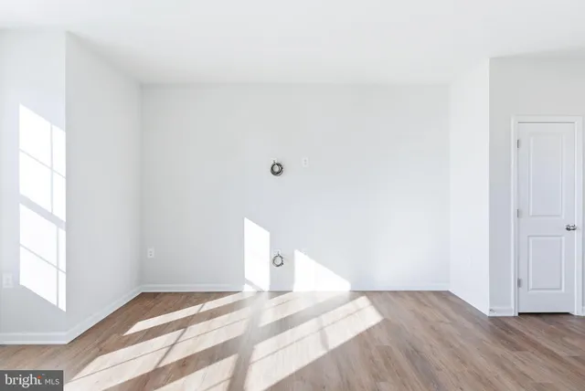 a view of a room with wooden floor and window