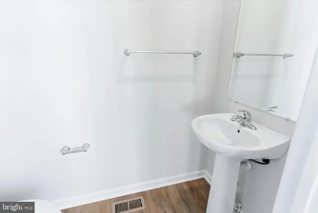 a bathroom with a sink and mirror