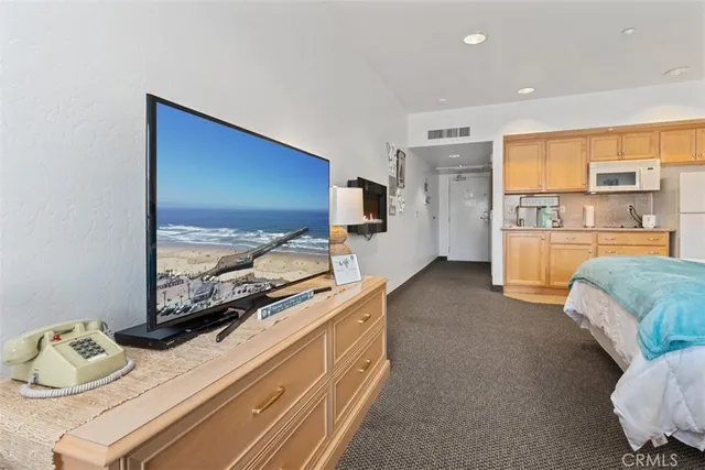 a bedroom with furniture and a flat screen tv