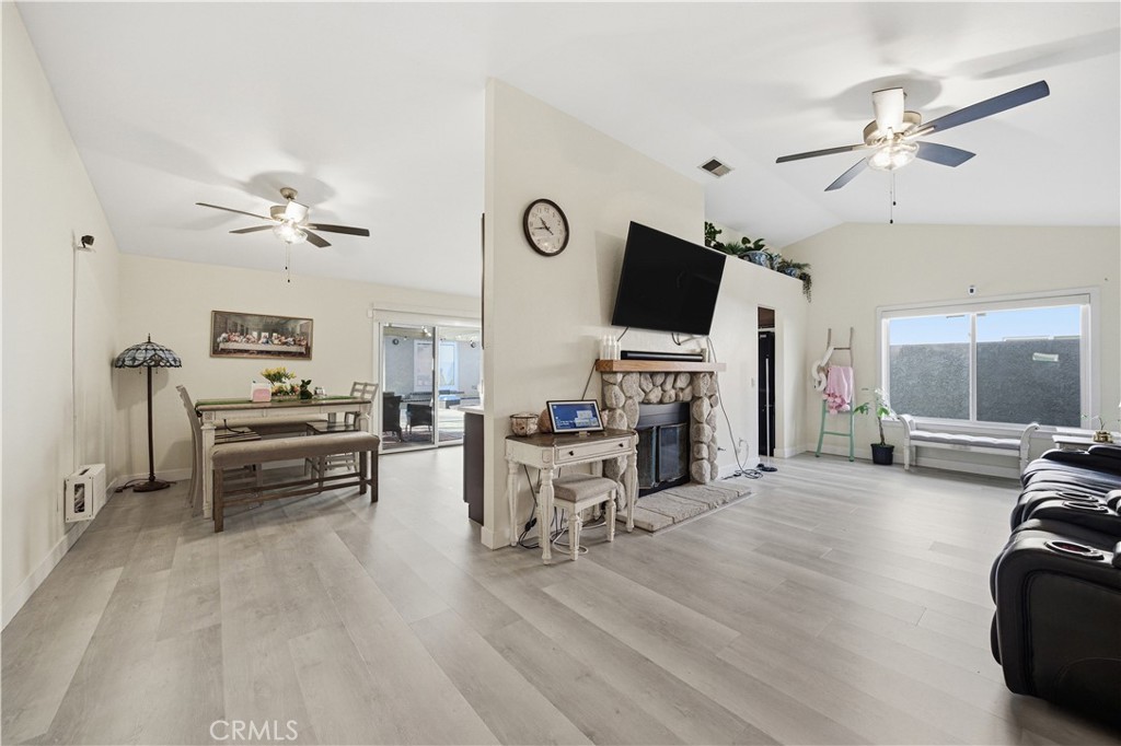 29739 Berea Road Menifee, CA 92584 - Photo 11 of 25 a living room with furniture a fireplace and a flat screen tv