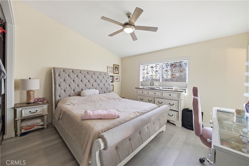 29739 Berea Road Menifee, CA 92584 - Photo 14 of 25 a spacious bedroom with a bed and a cabinets