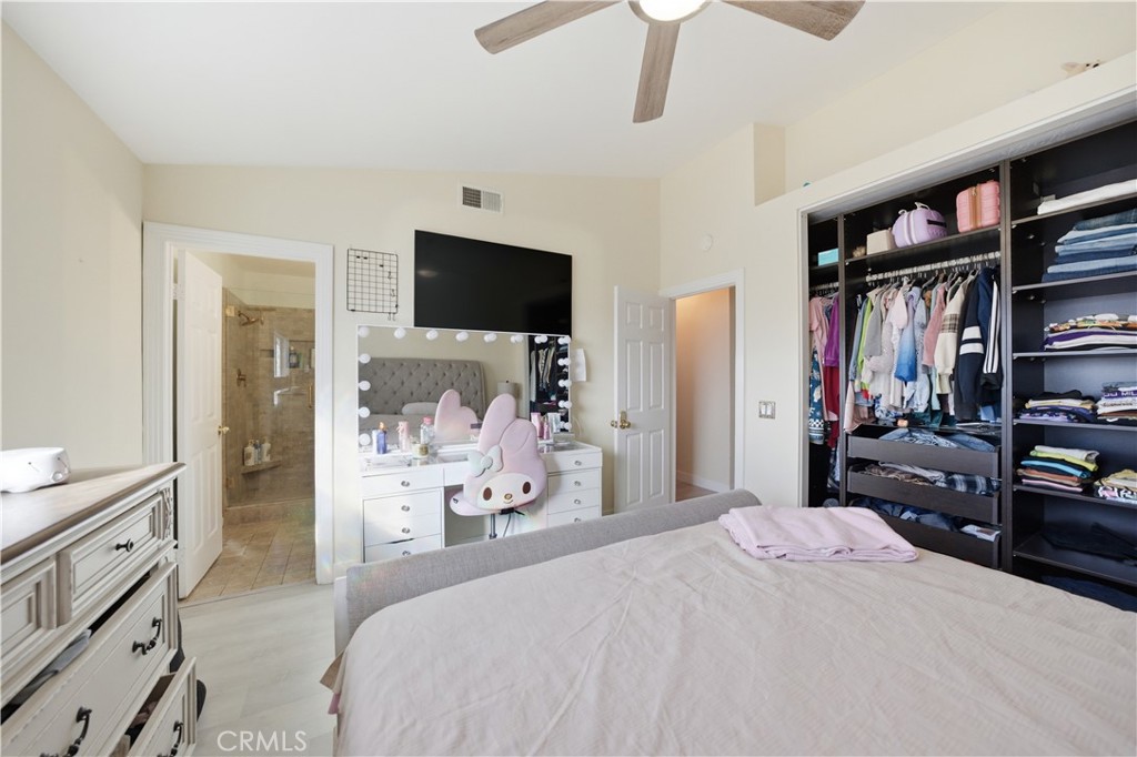 29739 Berea Road Menifee, CA 92584 - Photo 15 of 25 a bedroom with a bed and a television