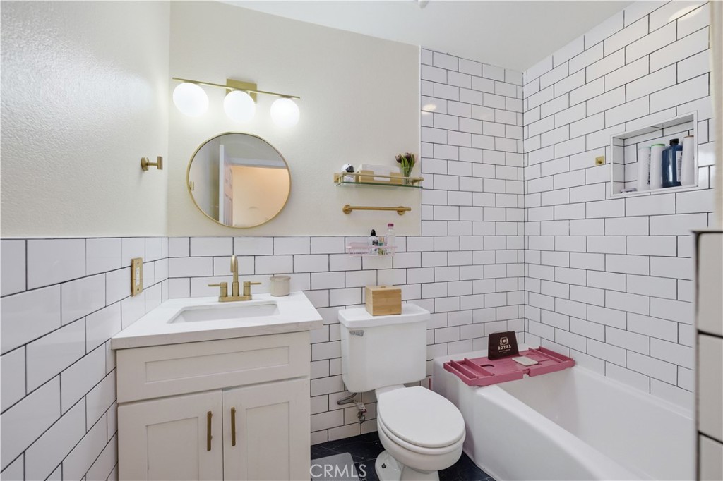 29739 Berea Road Menifee, CA 92584 - Photo 18 of 25 a bathroom with a sink mirror toilet and vanity