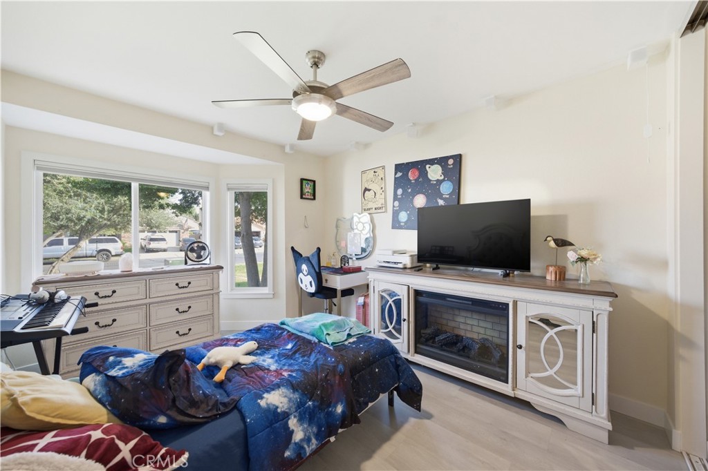 29739 Berea Road Menifee, CA 92584 - Photo 19 of 25 a bedroom with a bed and a flat screen tv