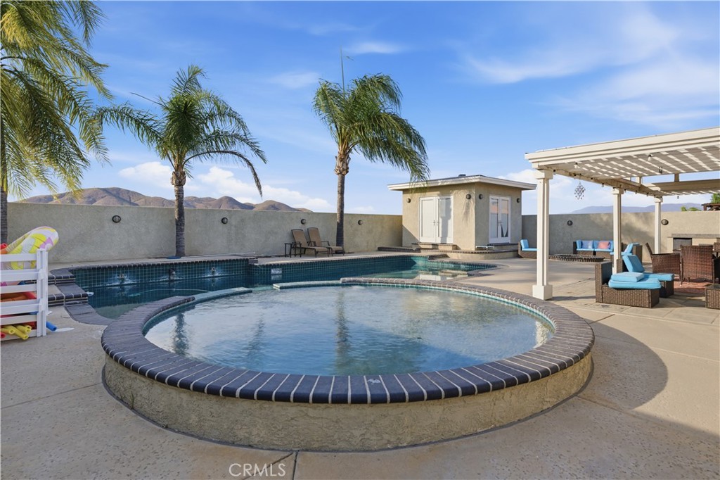 29739 Berea Road Menifee, CA 92584 - Photo 20 of 25 a view of a swimming pool with a lounge chair