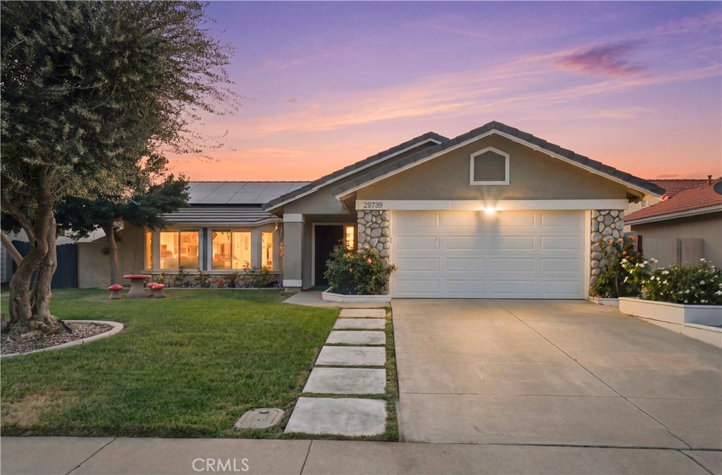 29739 Berea Road Menifee, CA 92584 - Photo 2 of 25 a front view of a house with a yard and garage