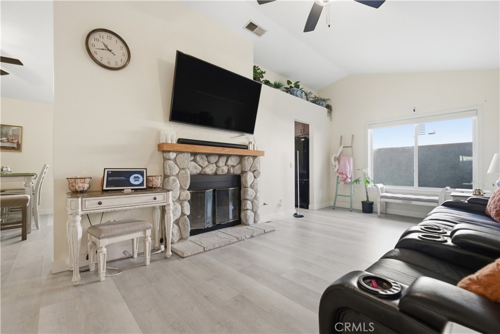 29739 Berea Road Menifee, CA 92584 - Photo 6 of 25 a living room with furniture a flat screen tv and a fireplace