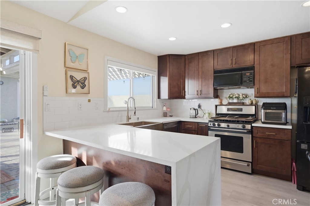29739 Berea Road Menifee, CA 92584 - Photo 8 of 25 a kitchen with a sink cabinets and stainless steel appliances