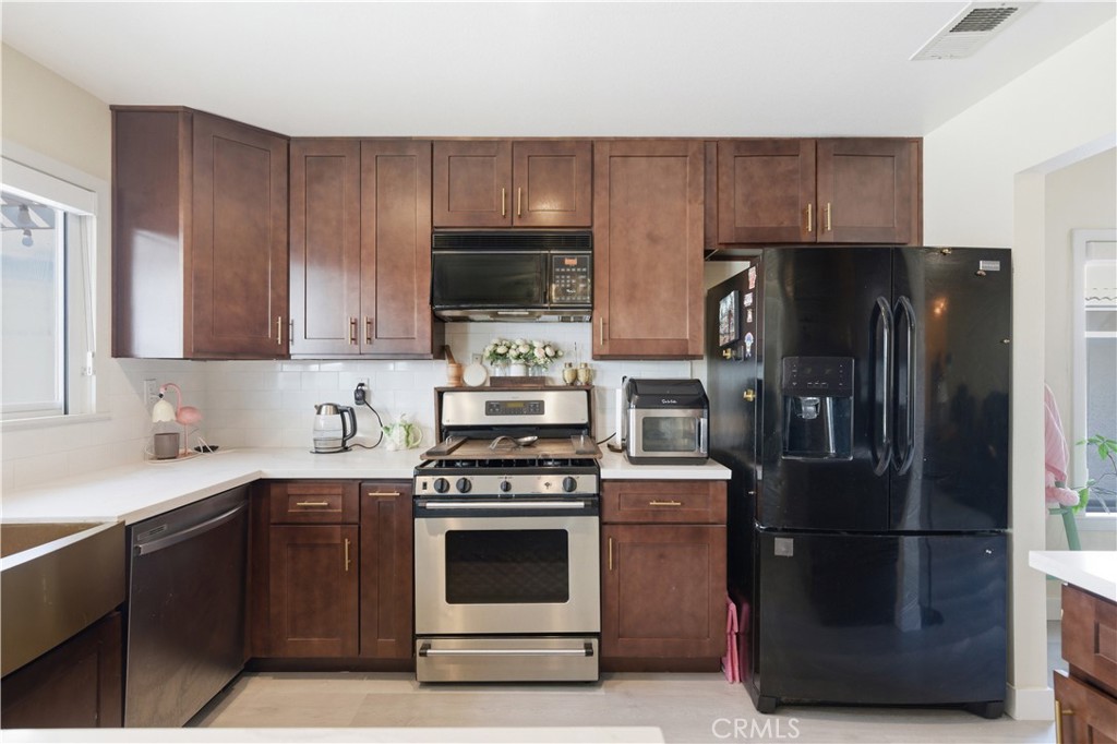 29739 Berea Road Menifee, CA 92584 - Photo 10 of 25 a kitchen with a refrigerator stove and microwave