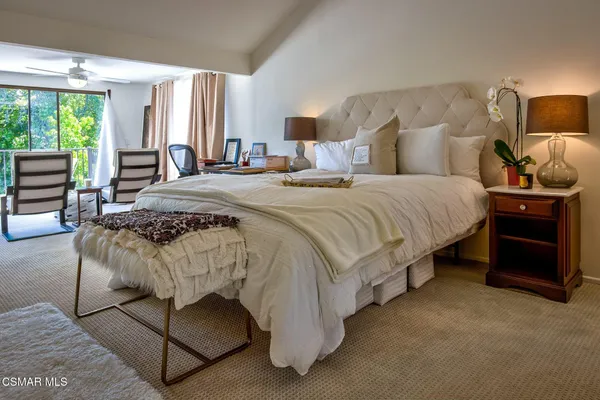 a bedroom with a bed and a lamp