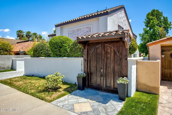 a view of a house with potted plants