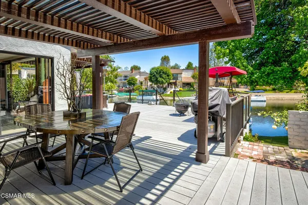 a wooden bench sitting in the backyard of a house