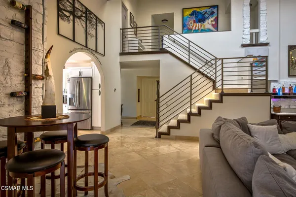 a view of a livingroom with furniture and stairs