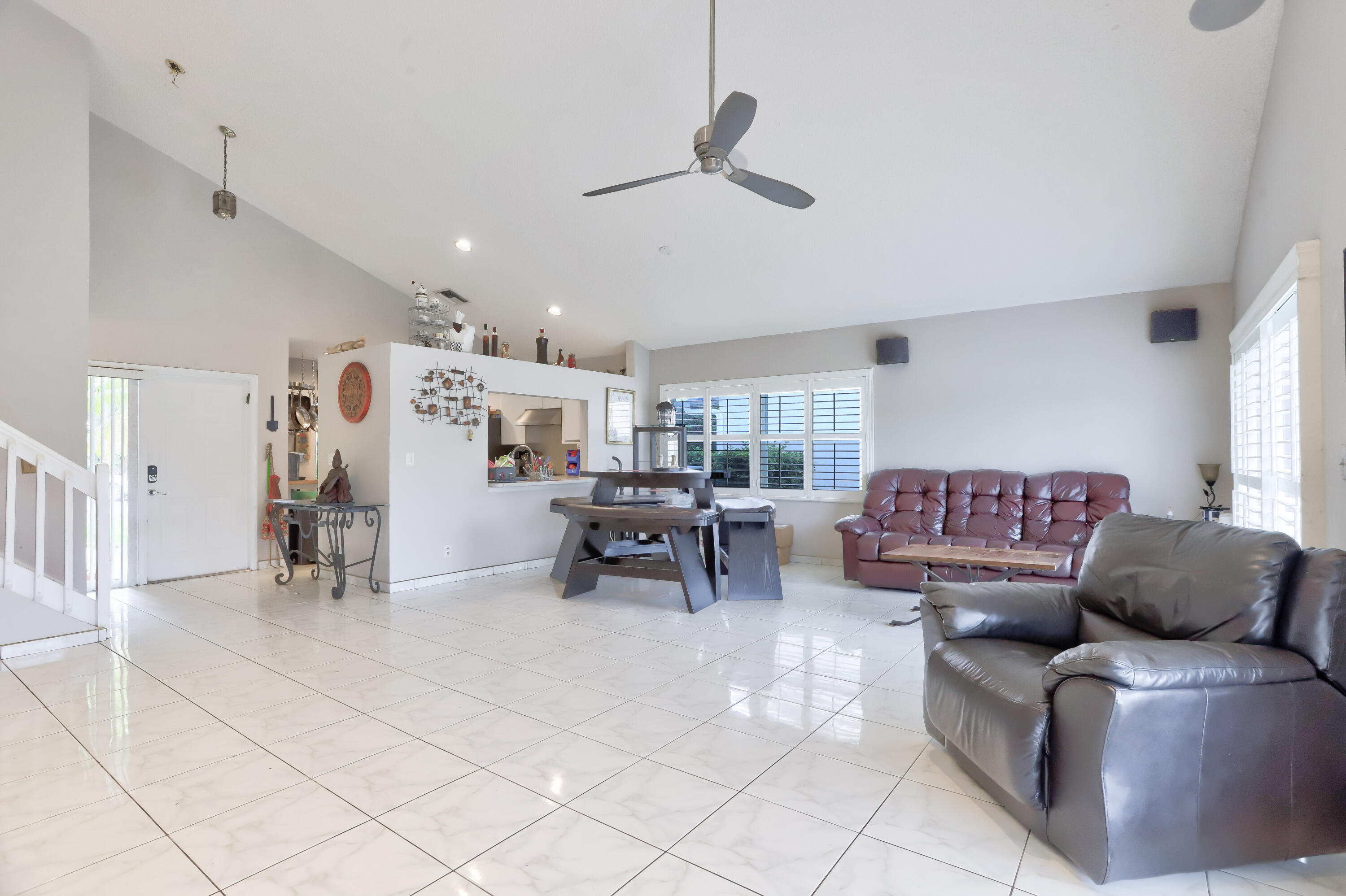 7427 Shell Ridge Terrace Lake Worth, FL 33467 - Photo 11 of 27 a living room with furniture and kitchen view