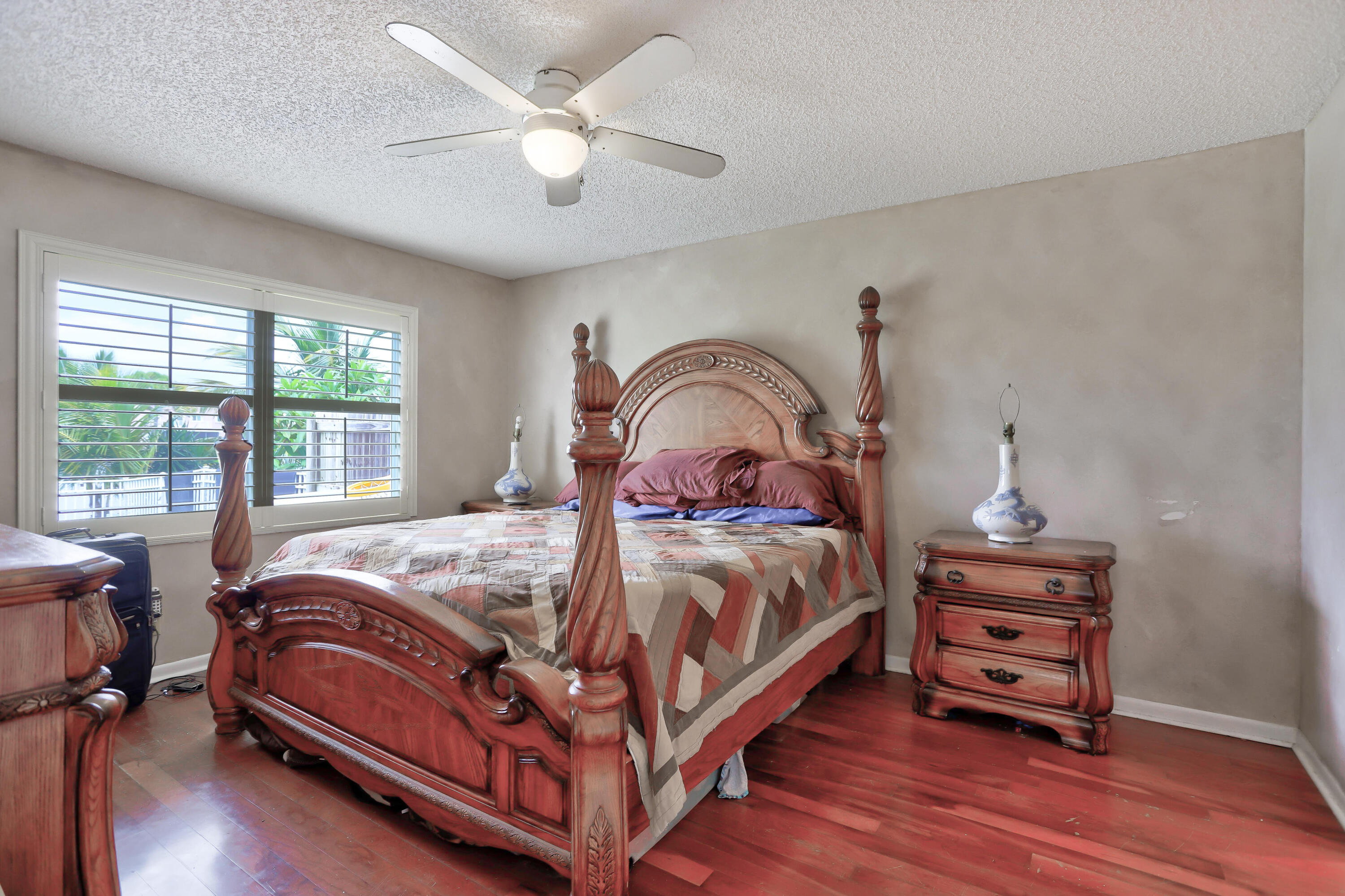 7427 Shell Ridge Terrace Lake Worth, FL 33467 - Photo 22 of 27 a bed sitting in a bedroom next to a window