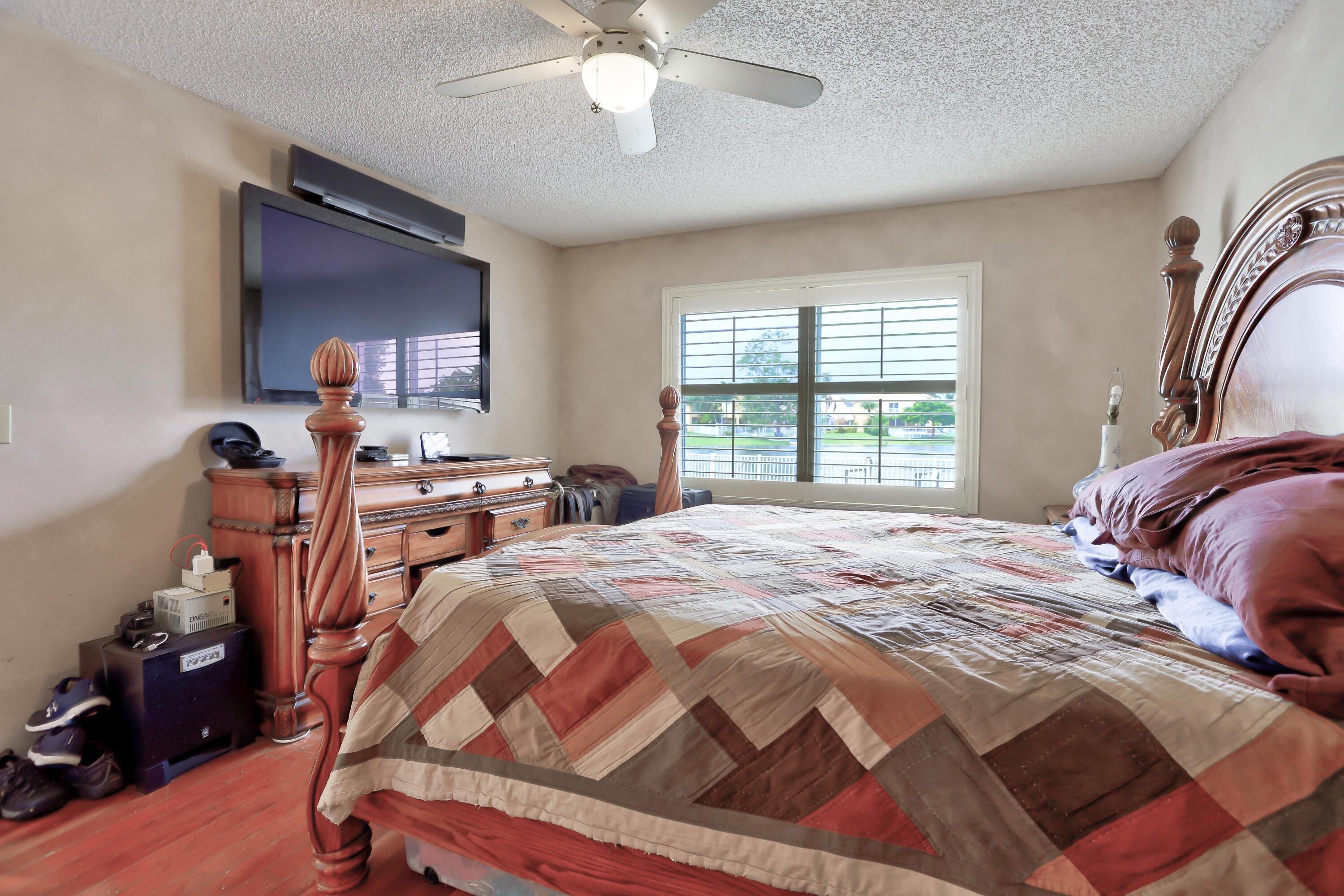 7427 Shell Ridge Terrace Lake Worth, FL 33467 - Photo 23 of 27 a bedroom with a bed and a chandelier