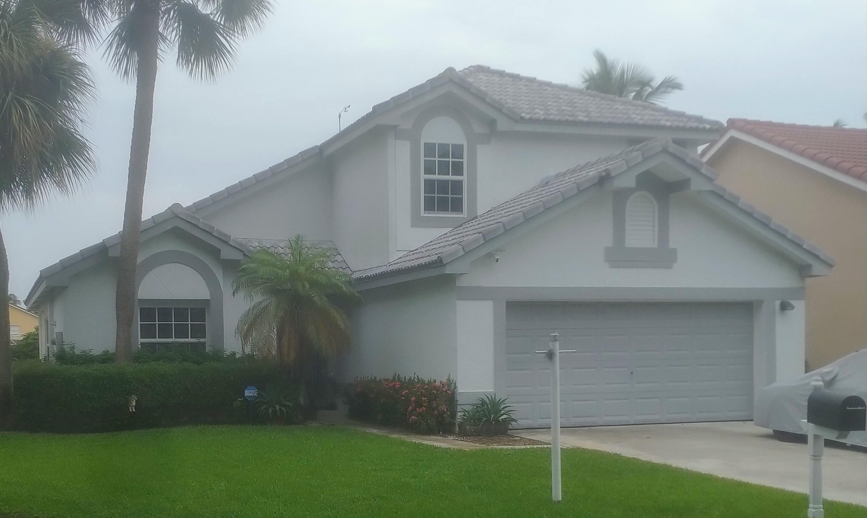 7427 Shell Ridge Terrace Lake Worth, FL 33467 - Photo 27 of 27 a front view of a house with a garden
