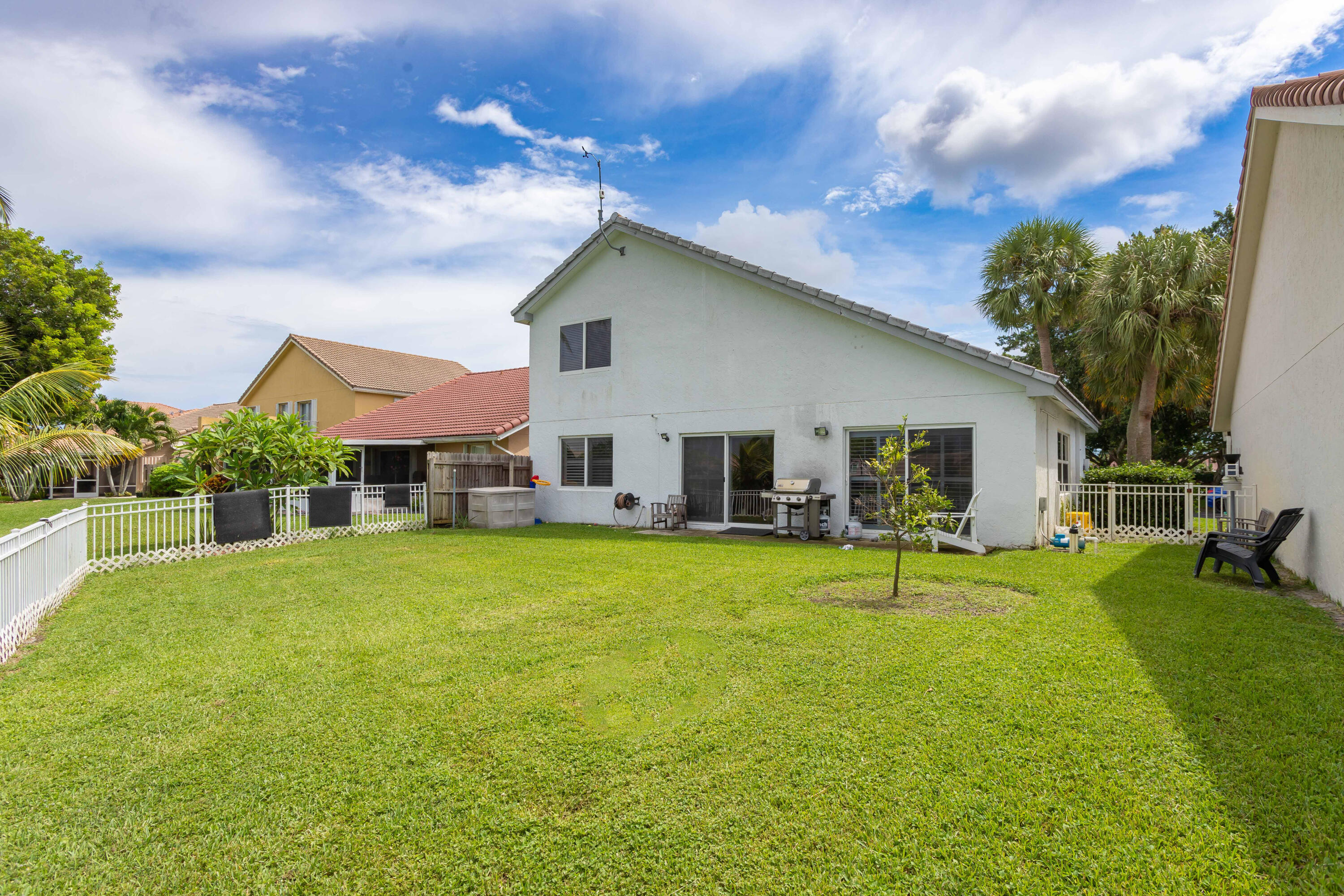 7427 Shell Ridge Terrace Lake Worth, FL 33467 - Photo 4 of 27 a house view with swimming pool and garden space