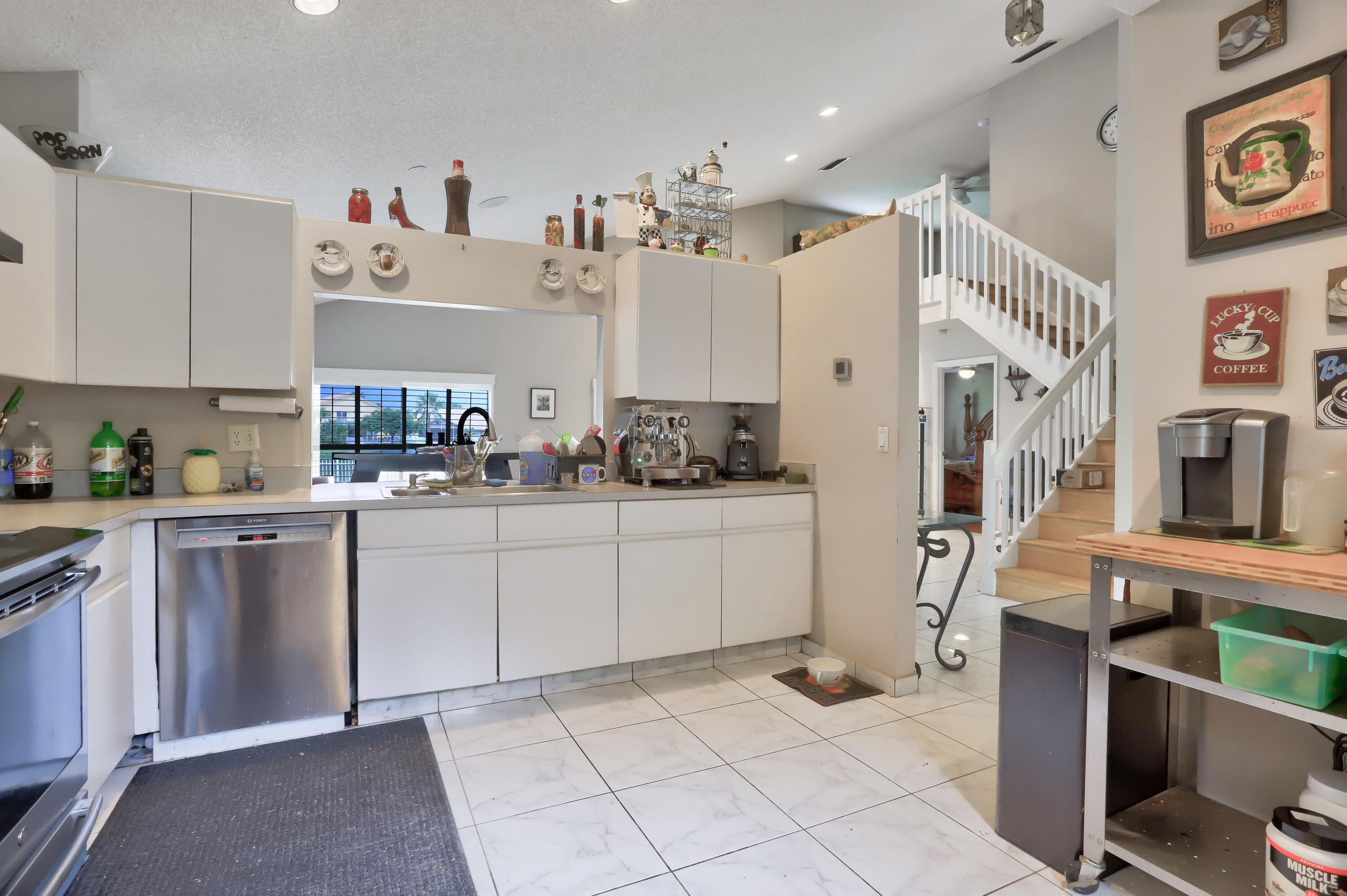 7427 Shell Ridge Terrace Lake Worth, FL 33467 - Photo 8 of 27 a kitchen with cabinets and window