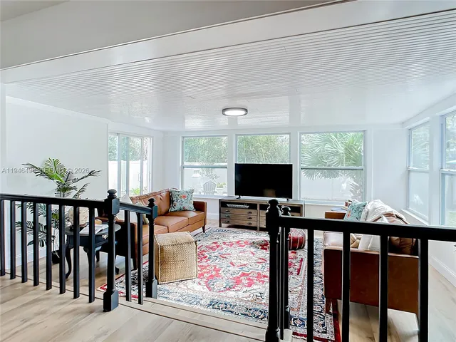 a view of a livingroom with furniture window and wooden floor